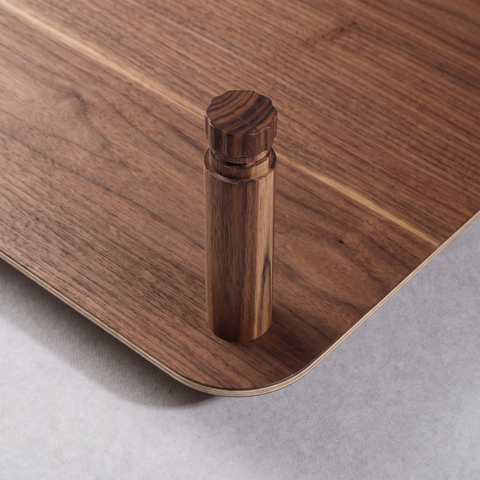 Close-up of the KittaParts threaded timber dowel joint in walnut, showing the peg fitting into the shelf corner