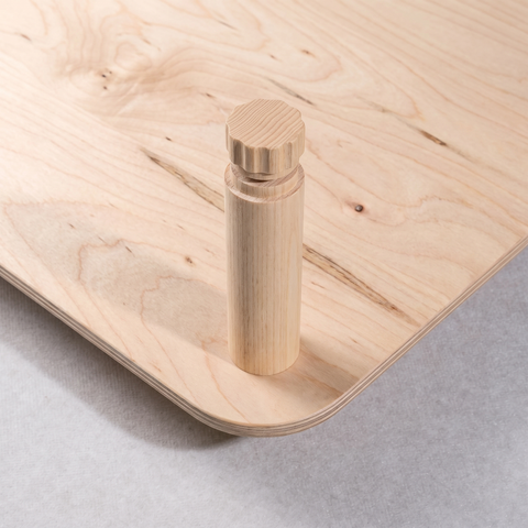 Close-up of the KittaParts threaded timber dowel joint in white birch, showing the peg fitting into the shelf corner